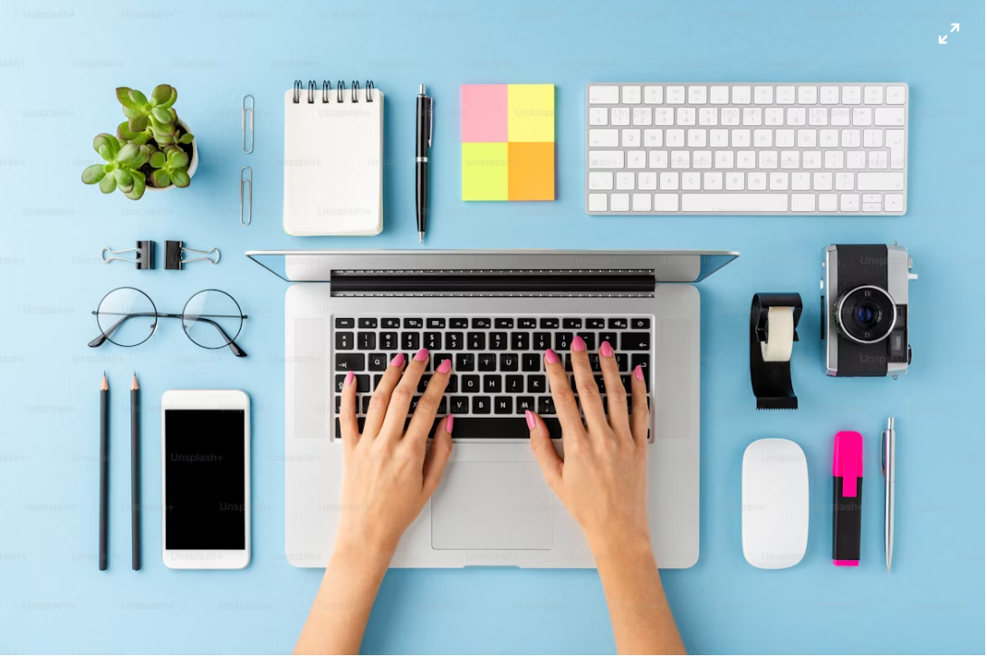 Person working on a laptop at a clean desk